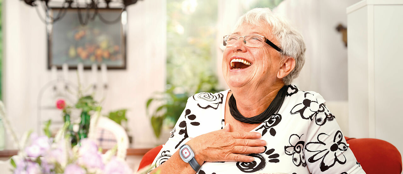 Bildarrangement Hausotruf: Seniorin m it Hausnotruf-Armband